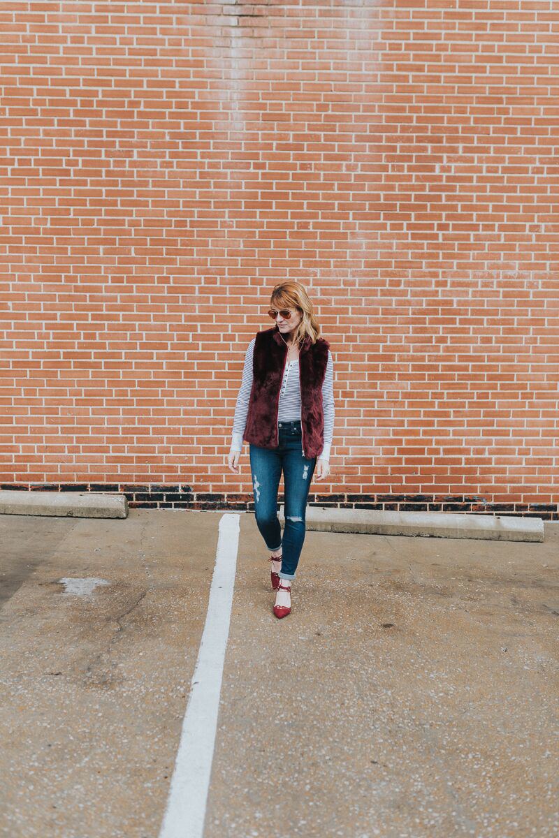 long sleeve henley tee paired with faux fur vest