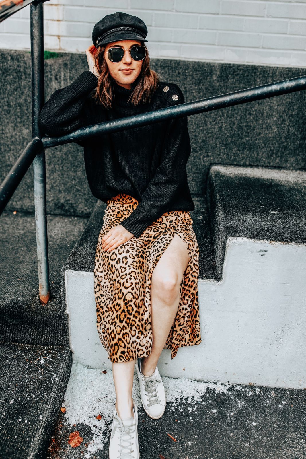 how to wear leopard | sneakers | leopard skirt | oversized black sweater | brixton hat | oh darling blog