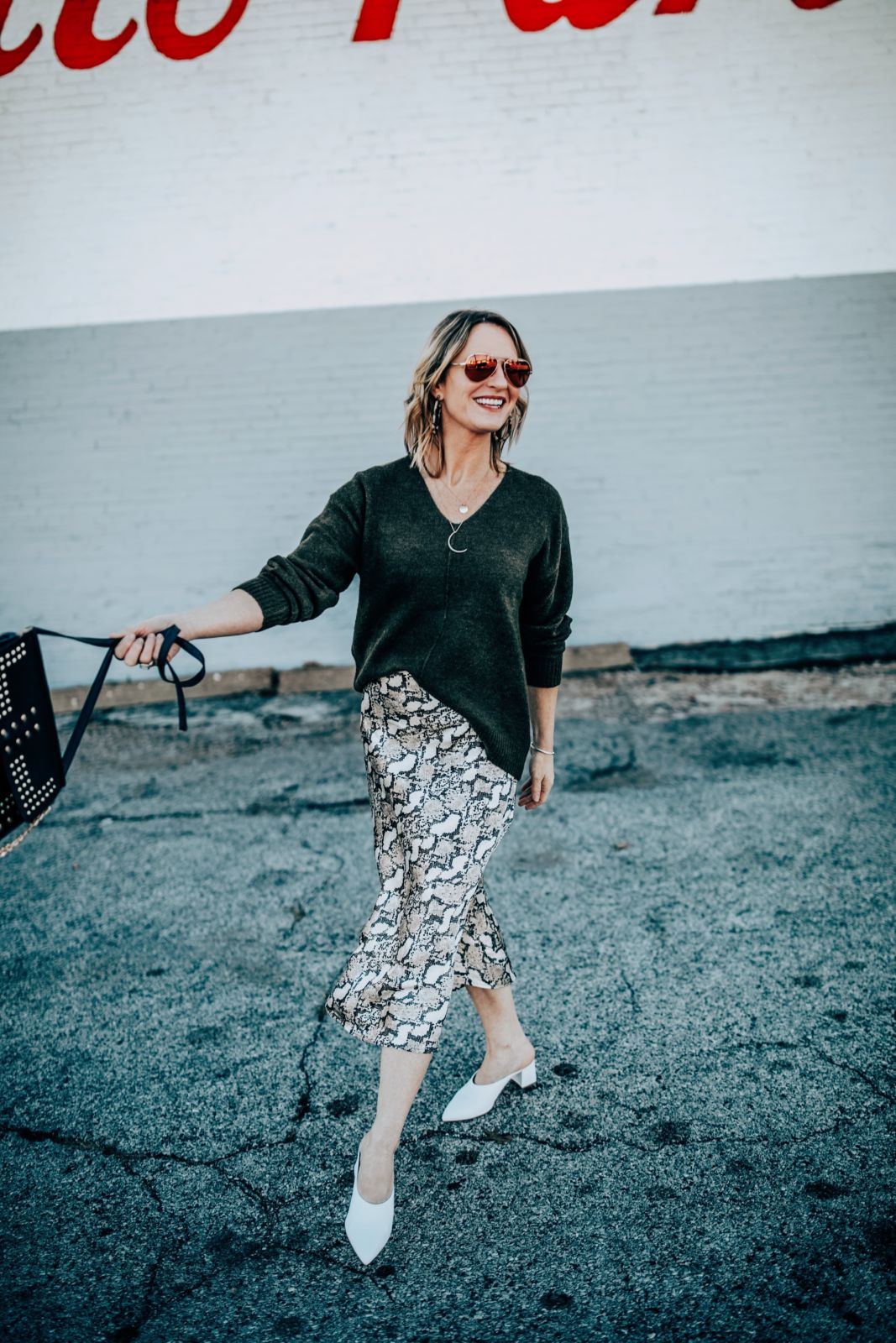 Winter Outfit Ideas: Snakeskin Print Skirt with a black V Neck Sweater and White Mules on Oh Darling Blog